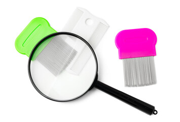A magnifying glass and lice comb placed side by side on a clean white background