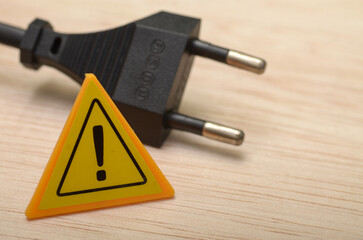 The image symbolizes the potential dangers of electricity and the importance of handling electrical...