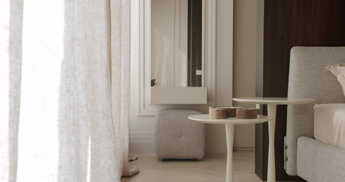 A stylish bedroom interior featuring minimalist furniture, elegant decor, and neutral tones. The modern design highlights a peaceful, calming ambiance perfect for relaxation.