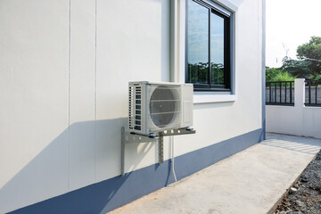 Condenser unit or compressor outside home or residential building. Unit of central air conditioner...