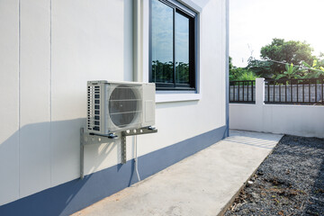 Condenser unit or compressor outside home or residential building. Unit of central air conditioner...