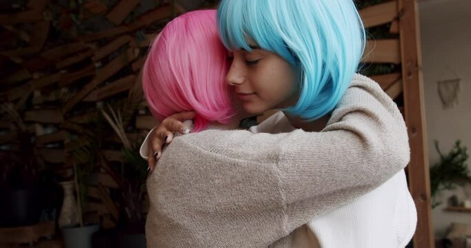 Friendship concept. Romance and portrait of lesbian couple with blue and pink hair enjoying. Two women sharing love and support holding hands. Lifestyle and relationships.