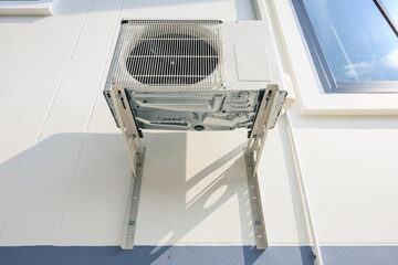 Condenser unit or compressor outside home or residential building. Unit of central air conditioner...