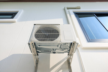 Condenser unit or compressor outside home or residential building. Unit of central air conditioner...