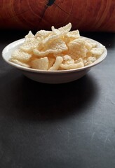 Close up of crispy rice crackers on a white bowl
