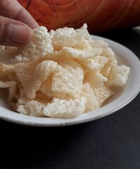 Close up of crispy rice crackers on a white bowl