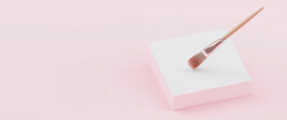 Paintbrush hovering over a blank canvas isolated on a pink background