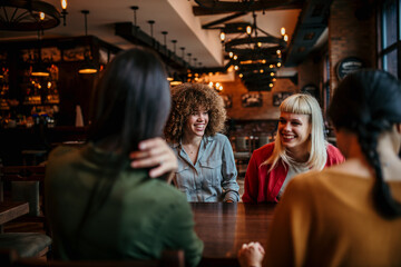 Friends having a good time, chatting in a restaurant