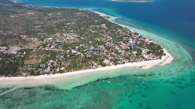 Bantayan island with turquoise waters, white sandy beaches, and lush coastal landscape, aerial view