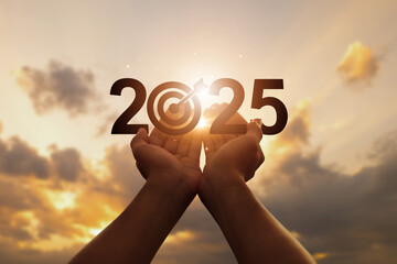 New year 2025. start a new year. Hand on the sunset sky with the Text 2025. opportunity, challenge and strategy in 2025. plans, goals and visions in business for the new year 2025. new year resolution