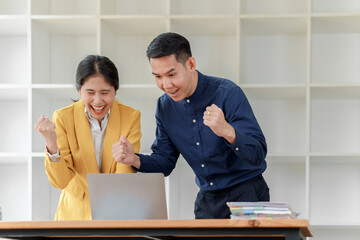 Celebrating success together office team cheering over laptop modern workspace joyful moment collaborative spirit