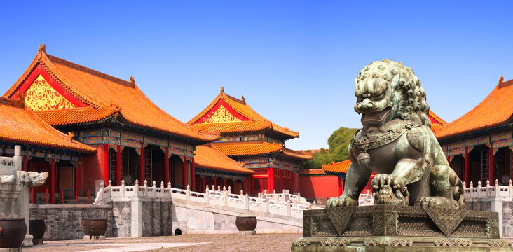 Horizontal background with ancient pavilions and lion statue in Forbidden City. Bronze chinese guardian lion, Beijing, China