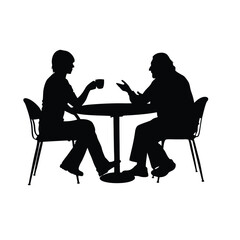 Two men sitting at a table. One man is drinking coffee. The other man is talking. There are two chairs
