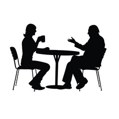 Two people sitting at a table. One of them is holding a cup. The table is round