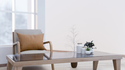 A minimal wooden armchair with a pillow and a coffee table in a minimalist white living room.