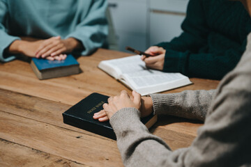  People reading and study bible in home and pray together.Studying the Word Of God