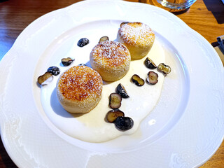 Cheesecakes for breakfast, decorated with fresh blueberry, with sour cream
