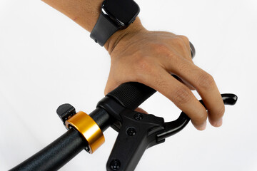 a man hand gripping the handlebars of a black bicycle