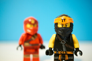 Naklejka premium Lego Ninja figures in a blue background.