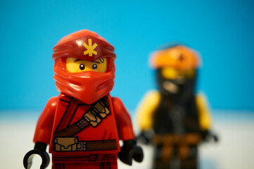 Naklejka premium Lego Ninja figures in a blue background.