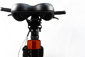 Fototapeta premium back of a black bicycle saddles and the handlebars are black with a white background
