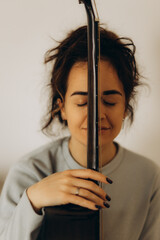 portrait of a woman hugging a guitar