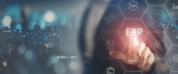 ERP system technology concept. Enterprise Resource Planning (ERP) system, featuring a business professional interacting with virtual icons for processes such as logistics, inventory and analytics.
