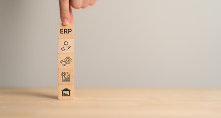 ERP system concept. Enterprise Resource Planning (ERP) represented through wooden blocks, each...
