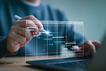 Project management concept. Site manager working with Gantt chart schedule to plan tasks and...