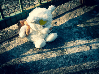 Teddy bear cement road with dark shadow, symbol child abuse violence sad domestic kid fear grief emotion sorrow scared concept for problem stress broken heart.