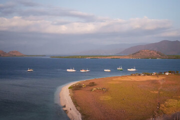 Fleet of Tourism Vessels and Hikers at Sunset
