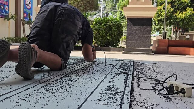 middle age man cutting processing ACP materials with cutting machine. modern industrial equipment.