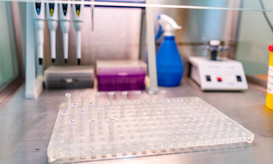 Lab work with pipettes and equipment. Several pipettes and lab equipment are organized on a...