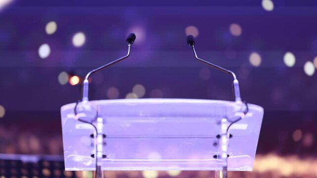 lectern desk. 4K video with a desk used by a speaker to deliver his message or speech during an event. empty lectern against digital background with two stereo microphones on it.