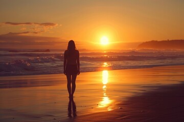 Young woman standing on beach at sunset
