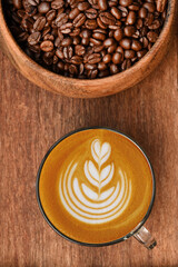  a cup of latte art coffee on wooden background                                                                                                                                                  