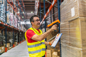 Warehouse worker scanning packages with barcode scanner