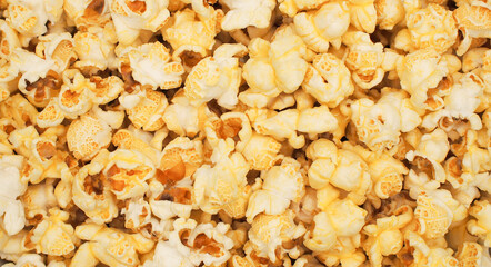 A scattered popcorn texture background with irregular clusters of fluffy popcorn pieces, varying in size and shape. perfect for casual or whimsical designs