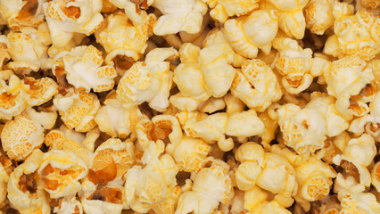 A scattered popcorn texture background with irregular clusters of fluffy popcorn pieces, varying in size and shape. perfect for casual or whimsical designs