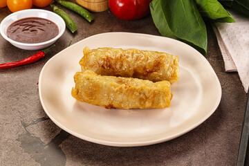 Vietnamese stuffed spring roll served sauce