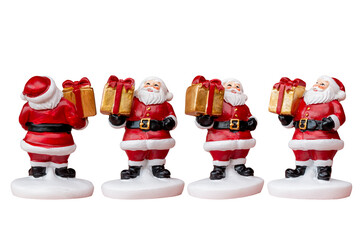 Miniature Santa Claus figurine with gift box dressed in a classic red suit isolated white background with a clipping path