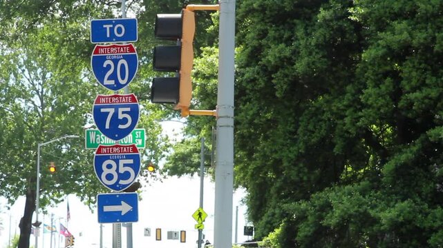 Highway intersection signs, including I-20 , I-75 and others, guide drivers with clear directions, marking key routes and exits on busy roadways