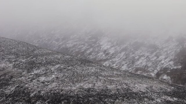 Snowy Mountains With Fog Clouds. Ogilvie Mountains In Yukon, Canada. drone sideways