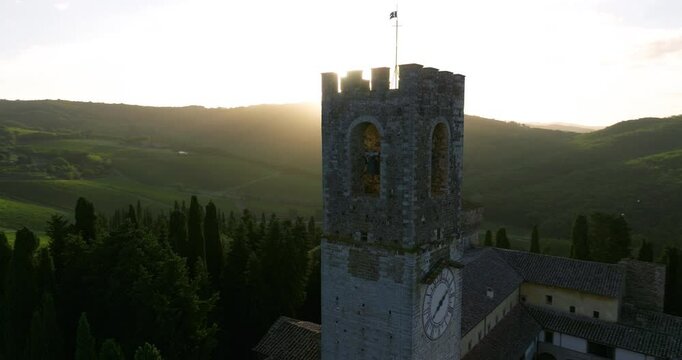 Clock Tower Of San Michele Arcangelo Passignano Abbey At Sunrise In Tavarnelle Val di Pesa, Province of Florence, Italy. Aerial Orbiting Shot