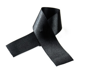 A black ribbon on a white background as a symbol of sadness, mourning or cancer awareness.A black ribbon on a white background as a symbol of sadness, mourning or cancer awareness.