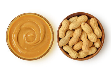 Peanut butter in glass bowl and shelled peanuts in wooden bowl on white background