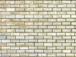 Light gray brick wall with a uniform pattern and slight discoloration, ideal for backgrounds or textures