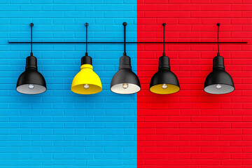 Naklejka premium Five hanging industrial lights, including one vibrant yellow light, against a split blue and red brick wall, showcasing a bold and minimalist design with striking color contrast.
