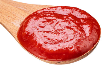 Wooden spoon of tomato sauce or ketchup close-up on a white background. Top view.