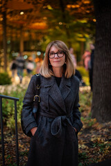 Attractive blond haired woman standing on the street